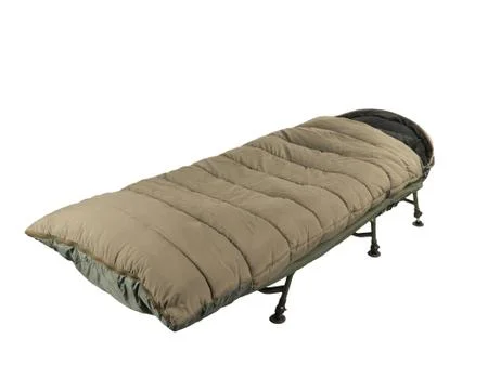 Camp bed with sleeping bag Stock Photos