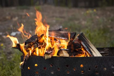 Camp fire burns Stock Photos