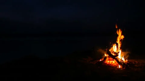 Camp fire on a lake in the night Stock Footage 63626740