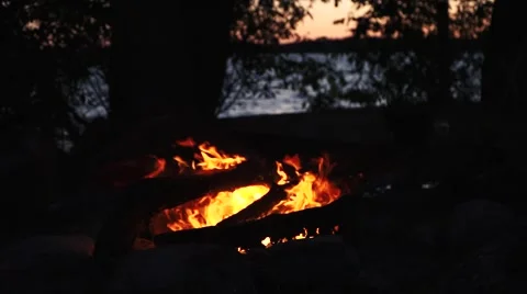 Camp fire by the lake at sunset - Slow Motion Stock Footage 66856295