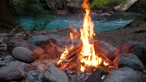 Camp fire by a river Stock Footage 123392289