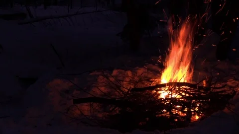 Camp fire in the snow at night Stock Footage 114145181
