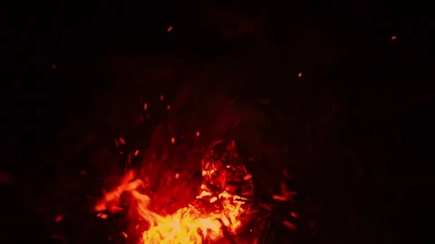 Camp fire with sparks motion burning in dark black background clip Stock Footage 327572876
