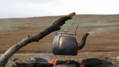 Camp kettle boiling on bonefire in the mountains Stock Footage 156406882