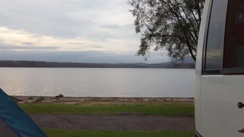 Camp tent and white van by the water Stock Footage 339096456