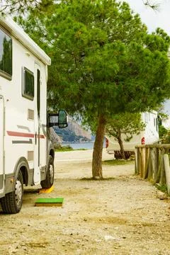 Camper camping on coast, using leveling block Stock Photos