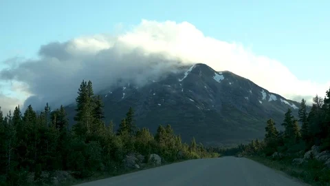 Camper Driving Along Highway at Sunset Beautiful Clouds Mountains Stock Footage 80717543