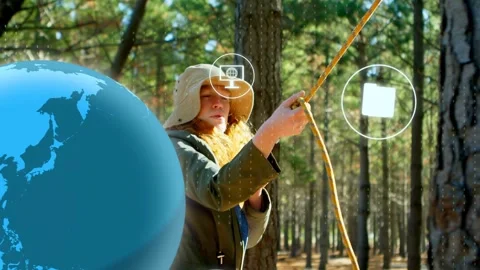 Camper finding slack pulling yellow rope to tree, tech globe and icons floating Stock Footage 333463603