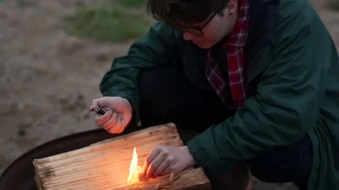 Camper Lights A Piece Of Paper To Start Campfire (Slow Motion) Stock Footage 78209533