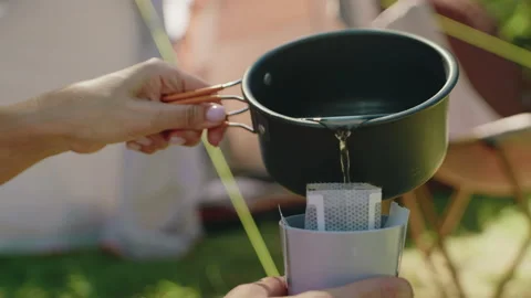 A camper makes coffee at a campground 動画素材 309384213