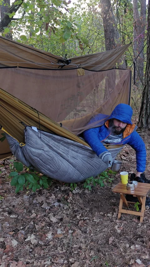 Camper Pouring Hot Water To Brew Coffee From Hammock In Forest Stock Footage 346550512
