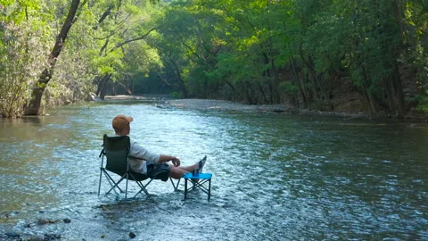 Camper relaxing by the river Stock Footage 310564074