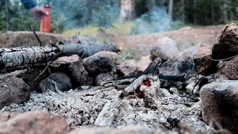Camper sitting by the nearly extinguishe... | Stock Video | Pond5