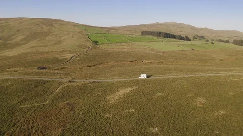 Camper travalling in the middle of feelds and forest Stock Footage 127489869