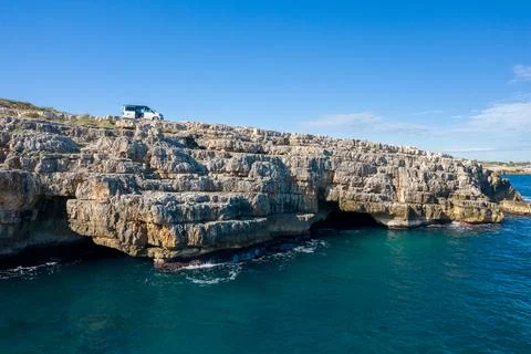 Camper van above limestone cliffs in Apulia Stock Photos