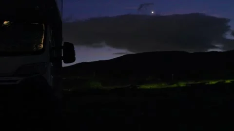 Camper van camping at night with traffic light trails Видео 340625206
