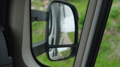 Camper van driving down country road reflected in side mirror Stock Footage 340264370