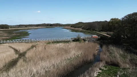 Camper van driving over small english bridge next to a river (Grade 4k) Stock Footage 247054738