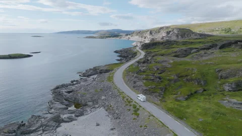 Camper van driving on a winding road in summer in Northern Norway Stock Footage 256677571