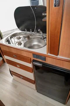 Camper van inside kitchen and fridge modern interior in luxury motorhome on r Foto stock