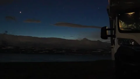Camper van parked during twilight transition to night sky with stars Stock Footage 340263618