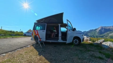Camper van parked in the mountains during a sunny summer day trip for van life Stock Footage 341540086