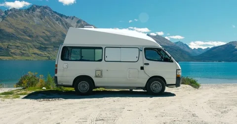 Camper van parked next to an idyllic lake Stock Footage 55447121