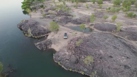 Campers Camping By The Riverside In Remote Area. - aerial shot Stock Footage 316296685
