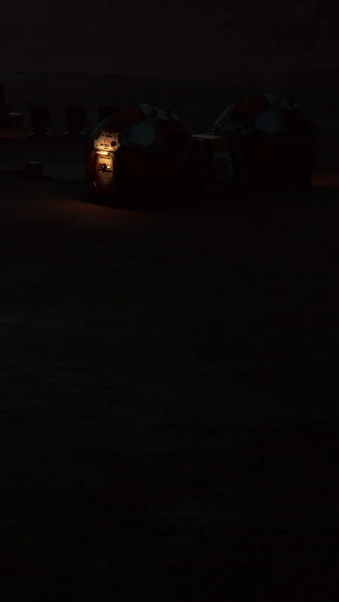 Campers gather around a light source in the dark night near tents Stock Footage 342109999