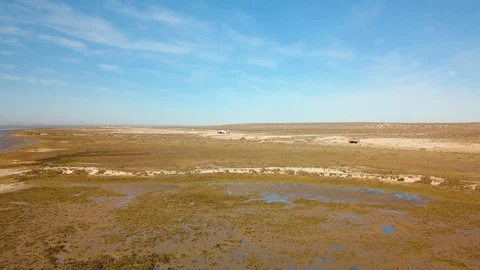 Campers in Ojo De Libre in Baja, Mexico. Aerial flying towards parked RV's Stock Footage 104668556