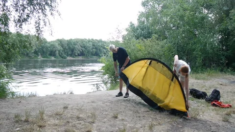 Campers putting up tent, preparing to overnight in wild, green tourism, hiking Stock-Footage 112245366