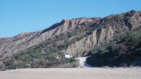 Campervan at Base of Beach Cliff Stock Photos