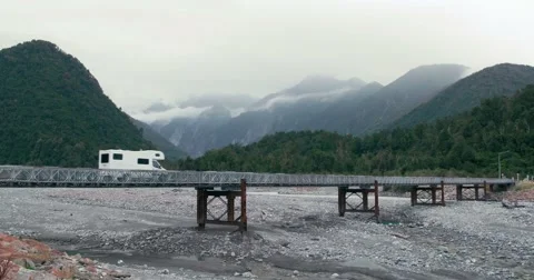 Campervan drives along bridge travelling through New Zealand Stock Footage 59807485