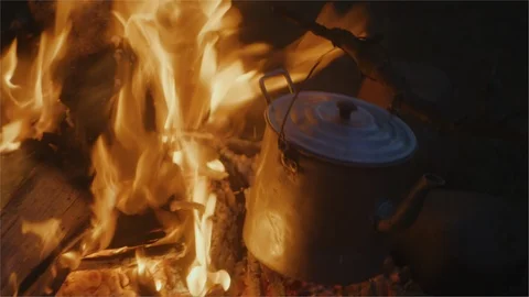 Campfire billy pot boiling in flames of a fire Stock Footage 107454760