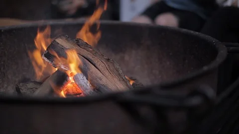 A campfire burning in a fire pit at dusk Stock Footage 91276056