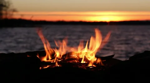 Campfire burning at lakeside during sunset Stock Footage 44517555