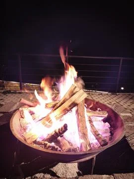 Campfire Burning Steadily in a Round Iron Bowl at Night Stock Photos