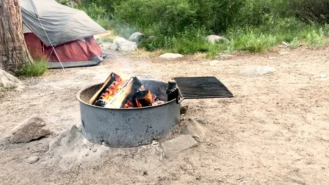 Campfire burning on a summer night camping with the family at the campground. Stock Footage 92393862