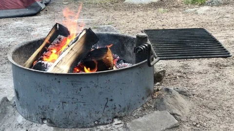Campfire burning on a summer night camping with the family at the campground. Stock Footage 92394465