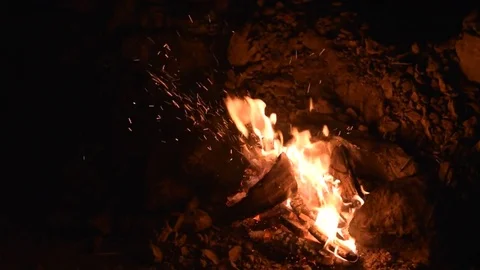 Campfire at a campsite that provides light and warmth, and heat for cooking Stock Footage 77886746
