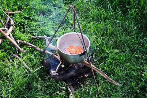 Campfire cooking in the field Stock Photos
