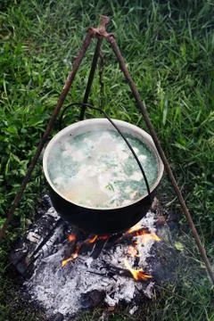 Campfire cooking in the field Stock Photos