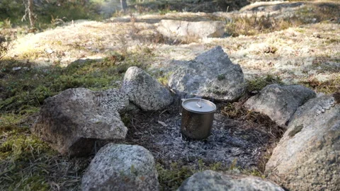 Campfire Cooking Pot Among Rocks in Forest Clearing 库存影片 333580910