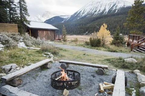 Campfire fire pit outside mountain cabin, Rocky Mountains, Canada Stock Photos