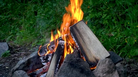 Campfire with firewoods surrounded by stones in the evening. Close-up. Stock Footage 201030292