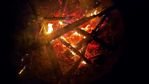 Campfire flames burn slowly in a cast-iron bowl, filmed at night in super s.. Stock Footage 297547879