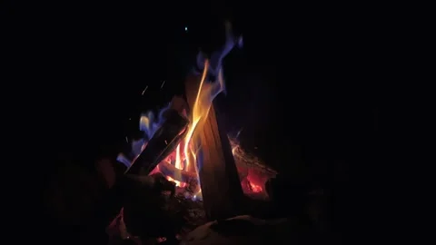 Campfire flames burning brightly at night, sparks rising into darkness Stock-Footage 347349955