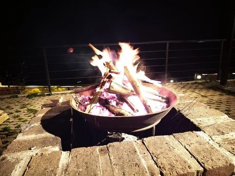 Campfire Flames Rising From Round Fire Bowl on a Cold Night Stock Photos