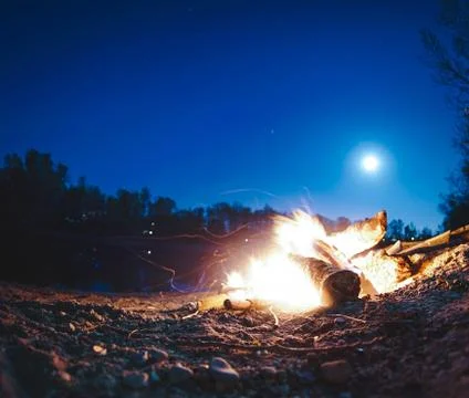 Campfire in front of the moonlight Stock Photos
