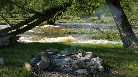 Campfire on mountain river Stock Footage 130095303